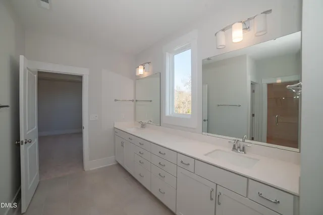 a bathroom with a double vanity sink and a mirror