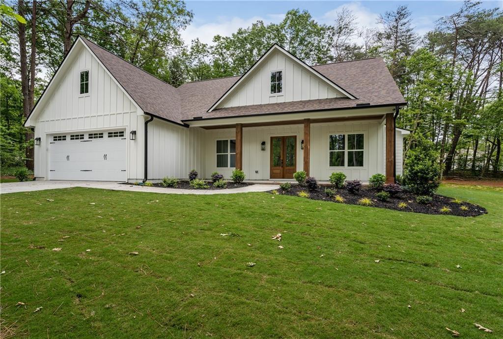 6 Lowe Lane Talking Rock, GA 30175 - Photo 1 of 10 a front view of a house with a yard and trees