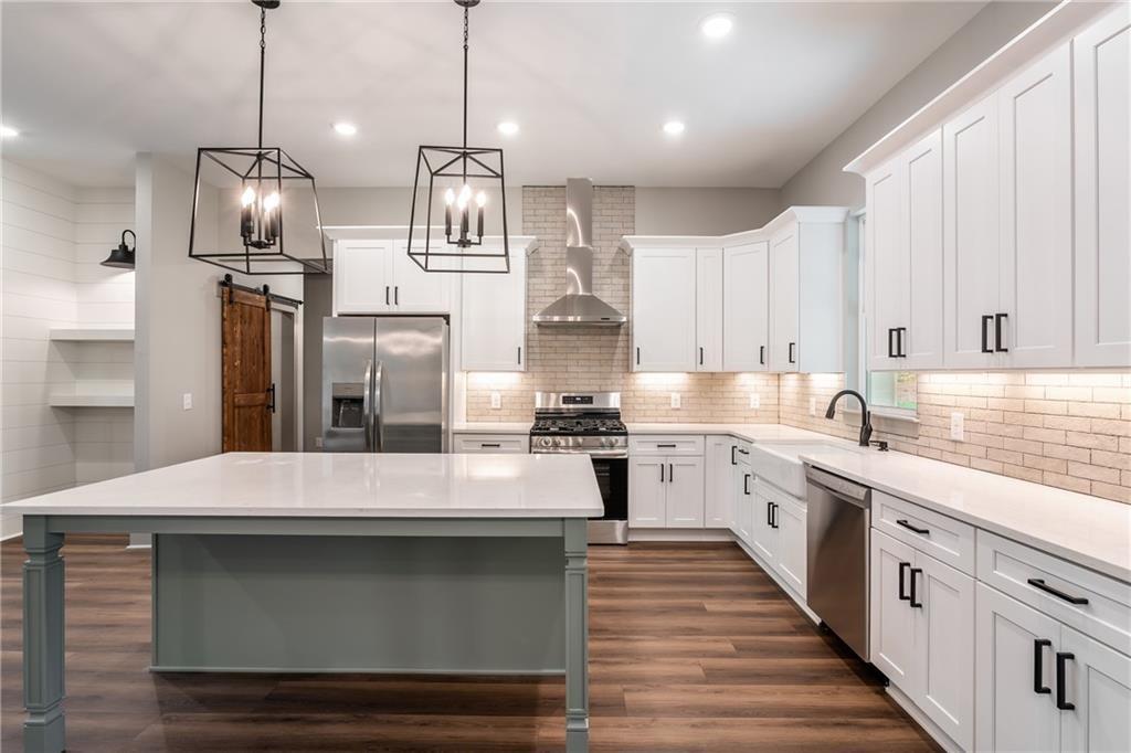 6 Lowe Lane Talking Rock, GA 30175 - Photo 5 of 10 a kitchen with stainless steel appliances granite countertop a sink a stove and a refrigerator