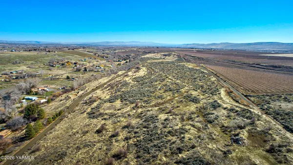 an aerial view of mountain with residential house and green space
