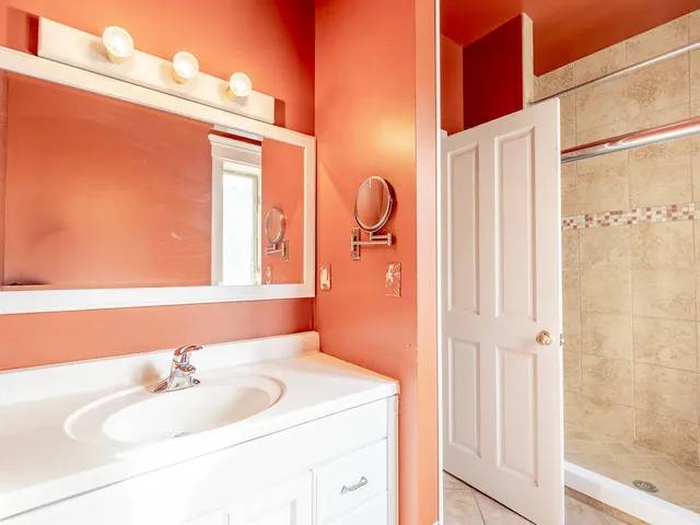 a room with white cabinets and window