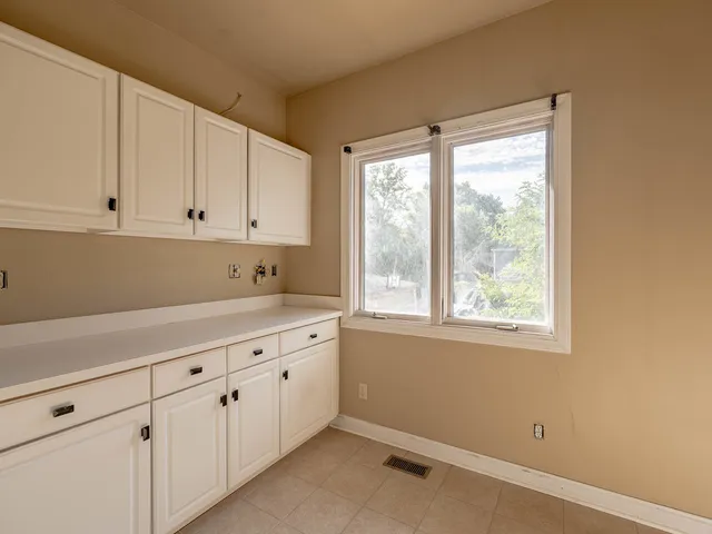 an empty room with windows and closet