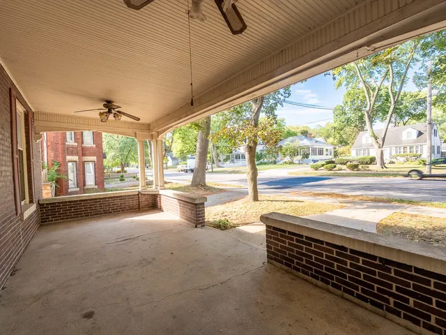 a view of an empty room with a floor to ceiling window and an outdoor view