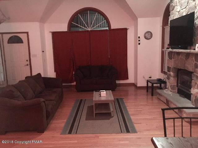 5139 Derby Road Tobyhanna, PA 18466 - Photo 3 of 8 a living room with furniture a flat screen tv and a fireplace