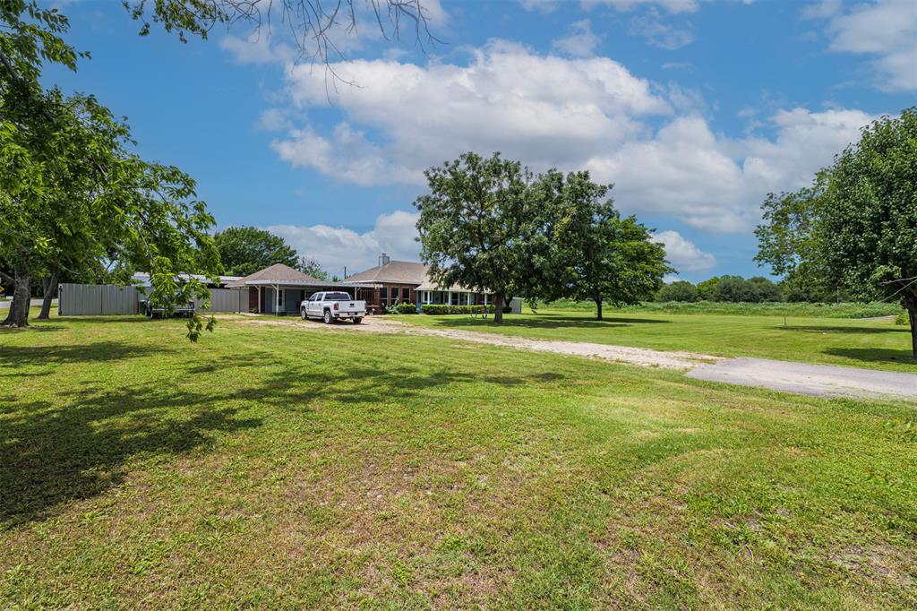 601 Houston School Road Red Oak, TX 75154 - Photo 32 of 32 View of grassy yard with driveway