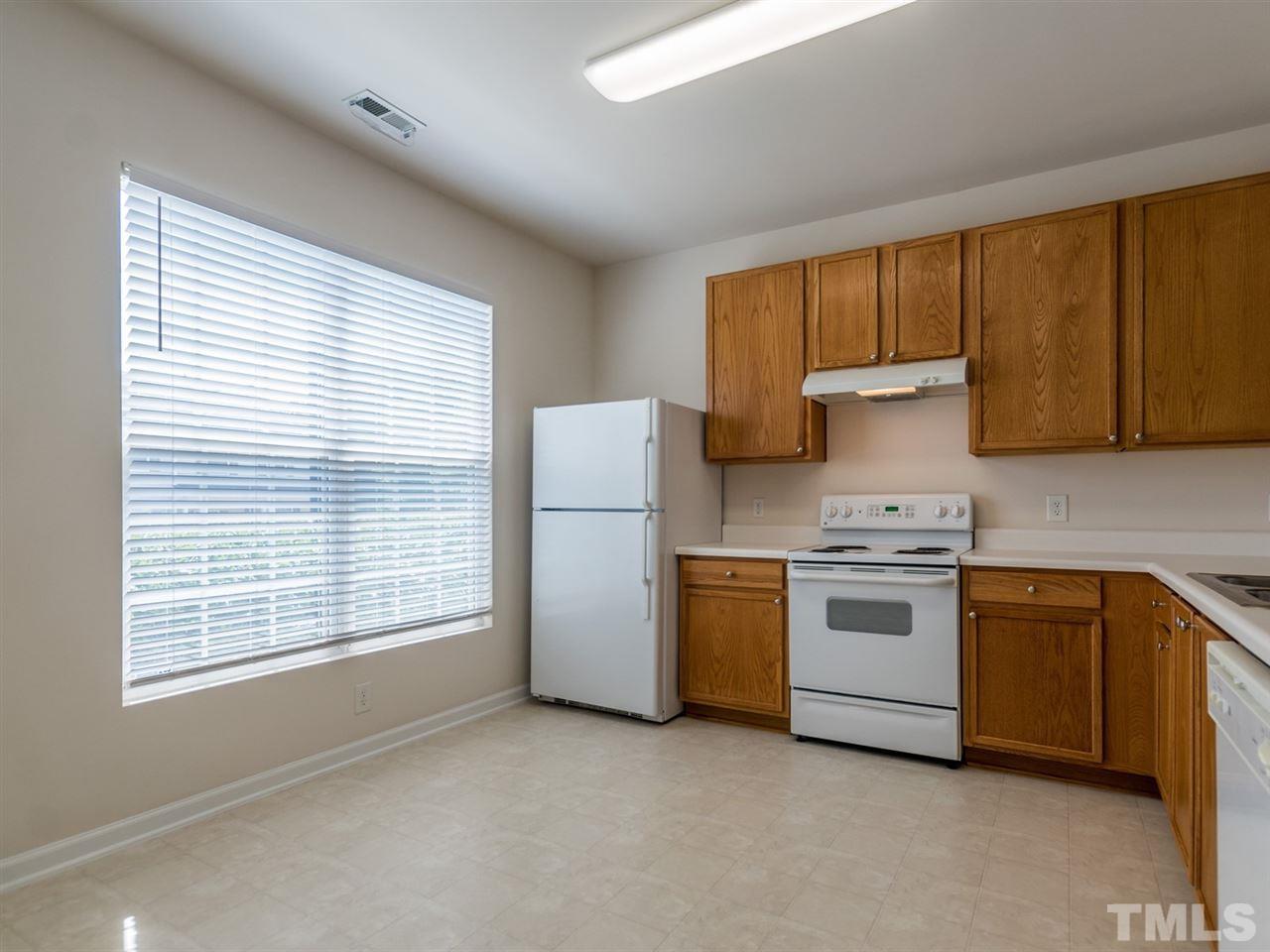 8518 Mt Valley Lane Raleigh, NC 27613 - Photo 4 of 20 a kitchen with a stove a sink and a refrigerator