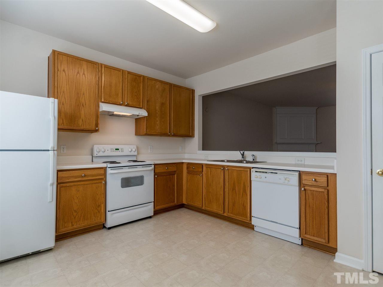 8518 Mt Valley Lane Raleigh, NC 27613 - Photo 5 of 20 a kitchen with stainless steel appliances granite countertop a stove a sink and a refrigerator