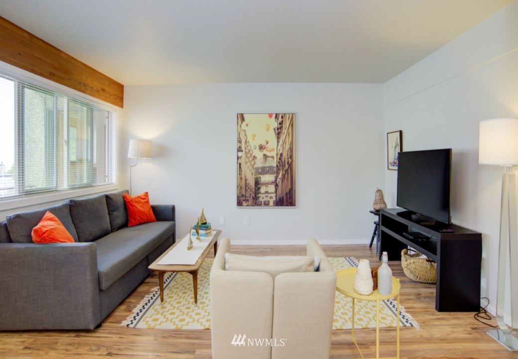 530 Bell Street Edmonds, WA 98020 - Photo 4 of 7 a living room with furniture and a flat screen tv with wooden floor