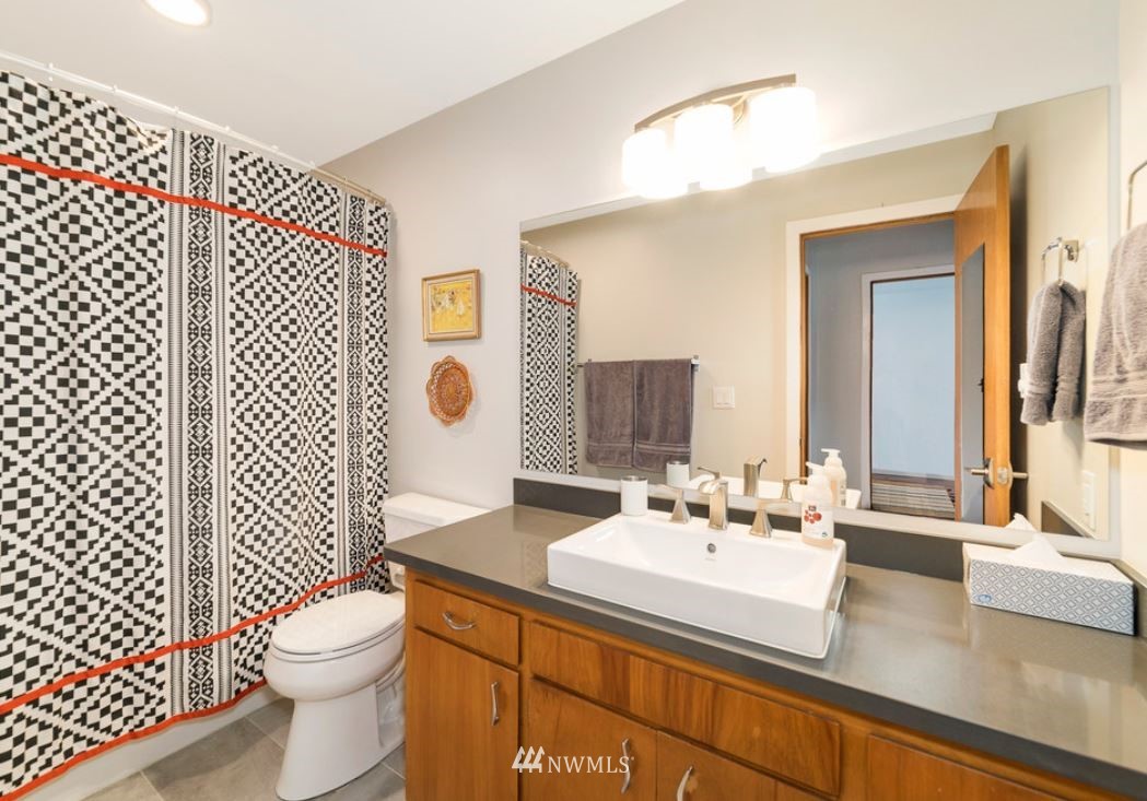 530 Bell Street Edmonds, WA 98020 - Photo 7 of 7 a bathroom with a sink a toilet and mirror