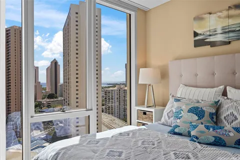 a bedroom with a large bed and a window