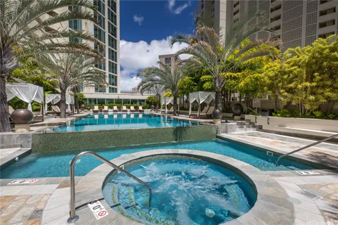 a view of swimming pool with outdoor seating and plants