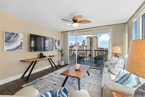 a living room with furniture a flat screen tv and a large window
