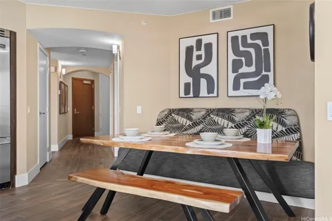 a view of a dining room with furniture and wooden floor