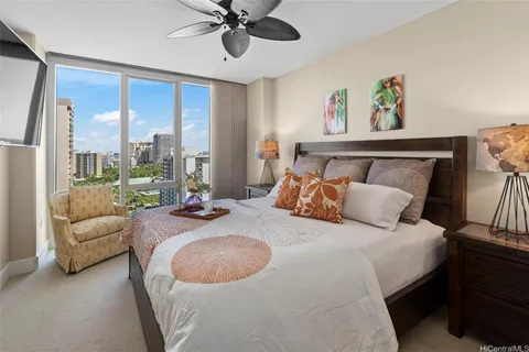 a bed room with a bed furniture and a large window