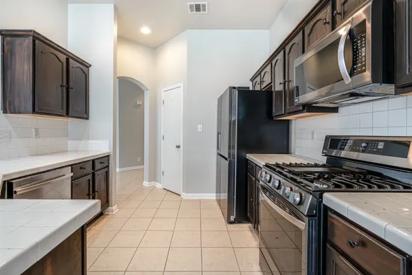 a view of a kitchen with a sink and a fireplace