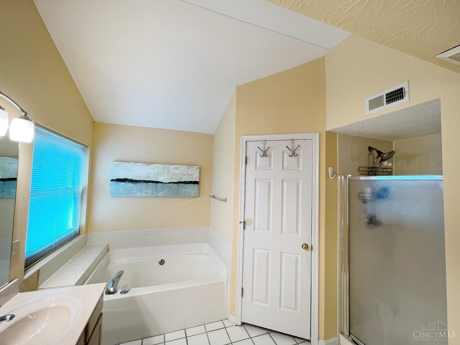 8408 Ridge Pointe Court, Unit 13 Reading, OH 45237 - Photo 17 of 39 This photo shows the garden bathtub, walk-in closet and separate shower.