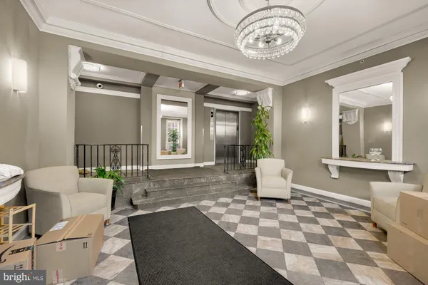 a living room with a couch and chandelier