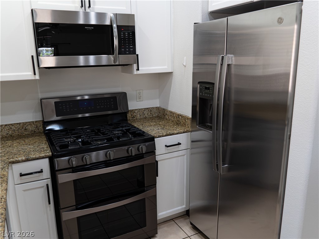 1466 Orange Jubilee Road Henderson, NV 89014 - Photo 3 of 15 A well-appointed kitchen features modern stainless steel appliances and durable granite countertops.