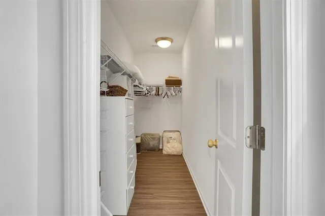 a spacious bedroom with a bed and a chandelier