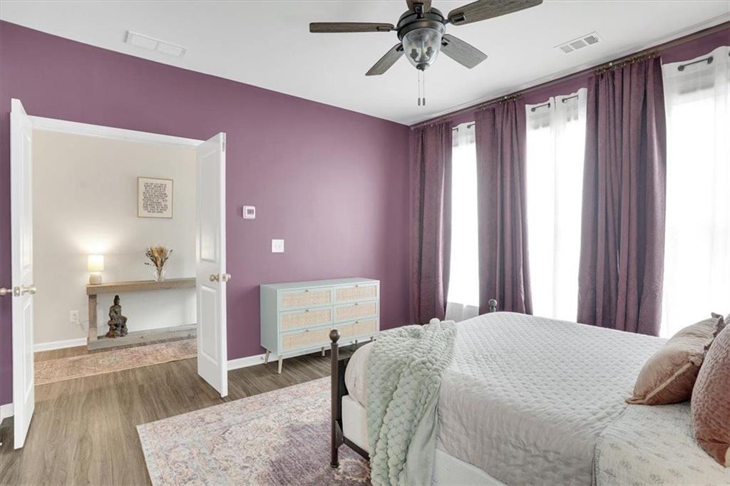 775 Hamilton Circle Southeast Atlanta, GA 30312 - Photo 19 of 24 a spacious bedroom with a bed and a chandelier