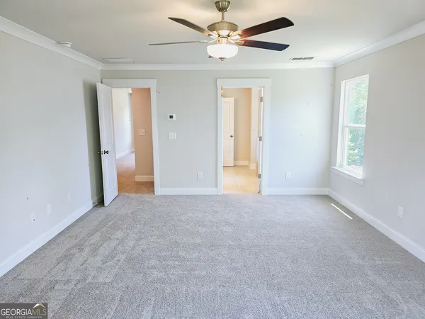 a view of a livingroom with a ceiling fan and window