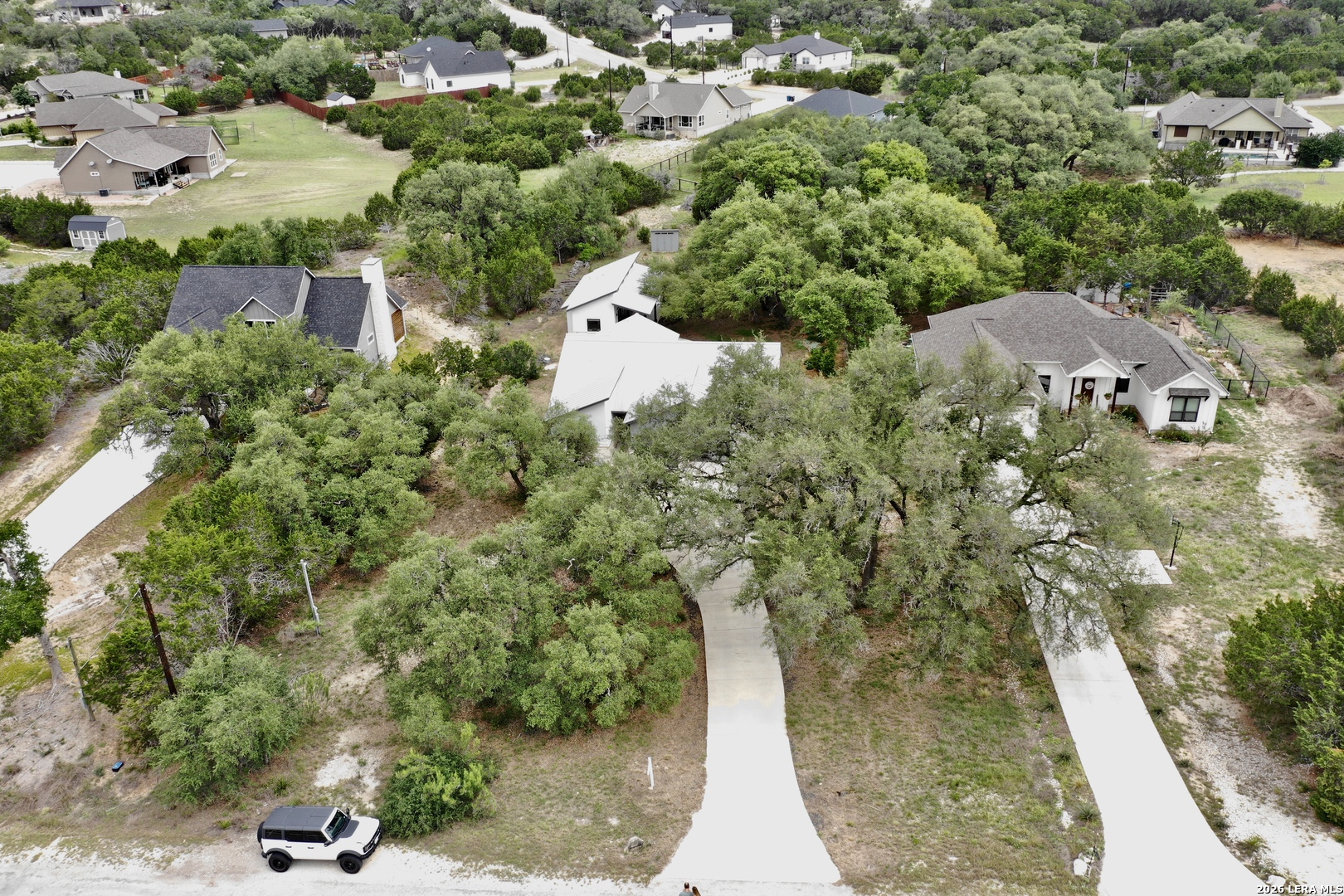 316 Prairie Tea Lane Spring Branch, TX 78070 - Photo 34 of 38 an aerial view of residential house with outdoor space and trees all around