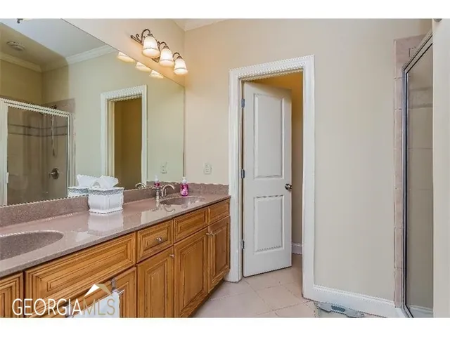 a bathroom with a sink a mirror and a shower