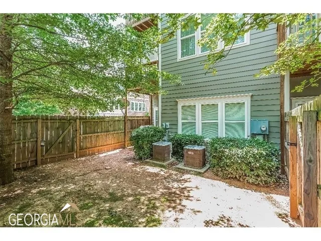 a backyard of a house with outdoor seating and plants