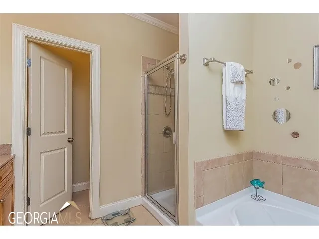 a bathroom with a shower and a sink