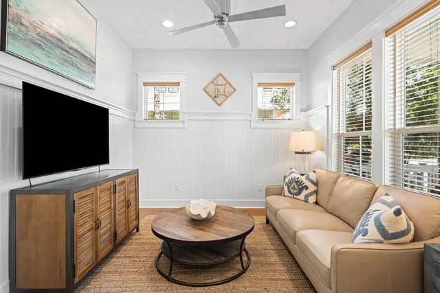 a living room with furniture and a wooden floor