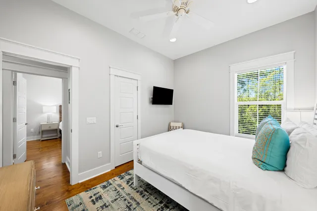 a en suite bathroom with a granite countertop sink and a window
