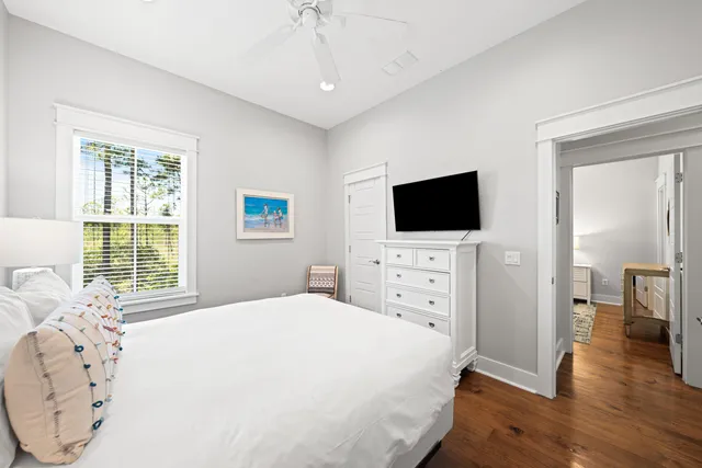 a bathroom with a granite countertop tub a double vanity sink a window and a mirror