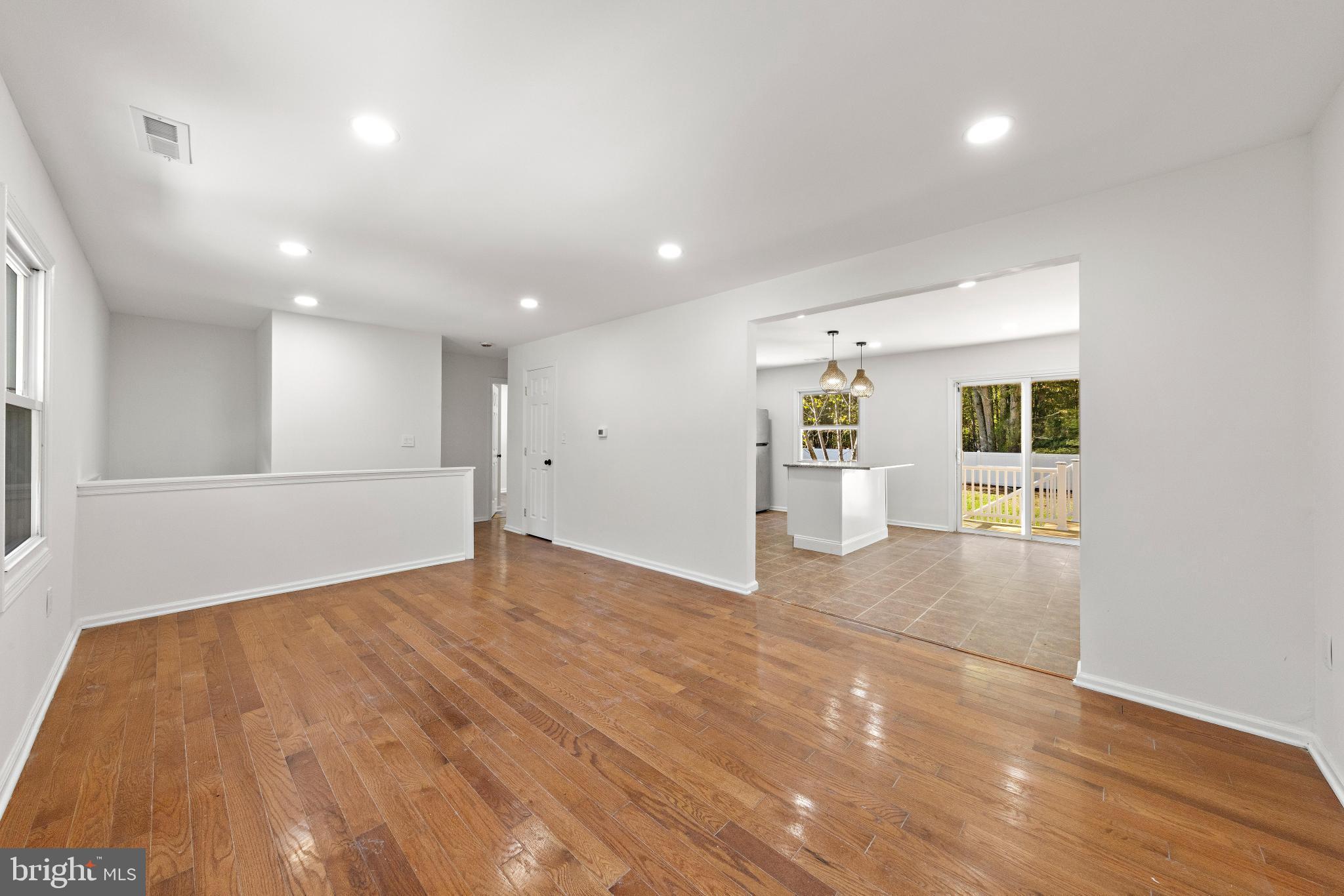 716 6th Road Newtonville, NJ 08346 - Photo 6 of 40 an empty room with wooden floor and windows