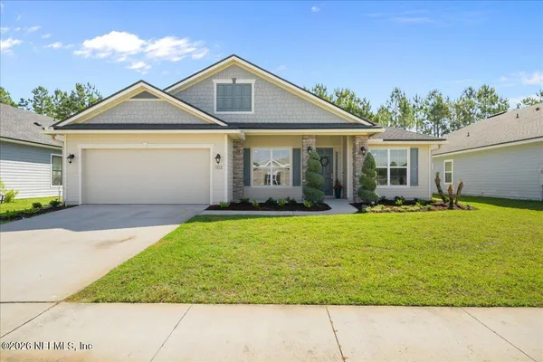 a front view of a house with garden