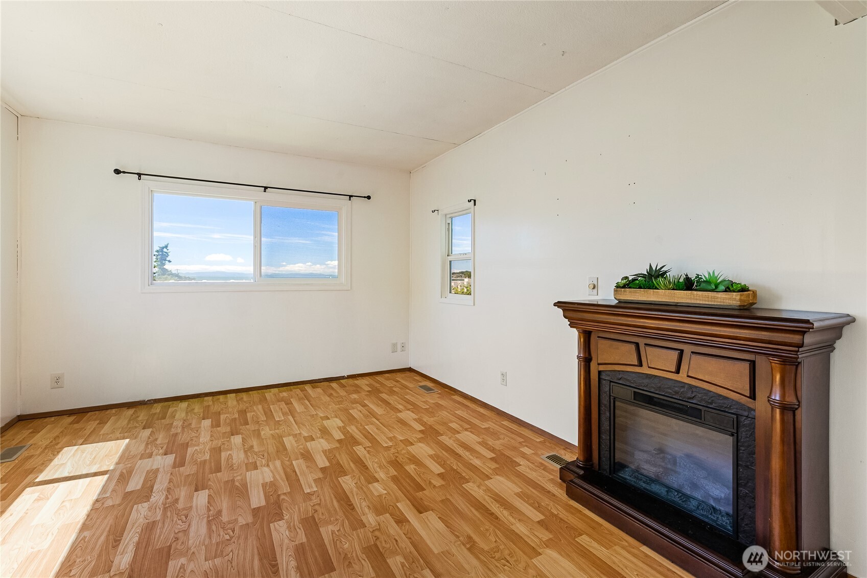 8080 Harborview Road, Unit 167 Blaine, WA 98230 - Photo 8 of 27 a view of an empty room with a fireplace and a window