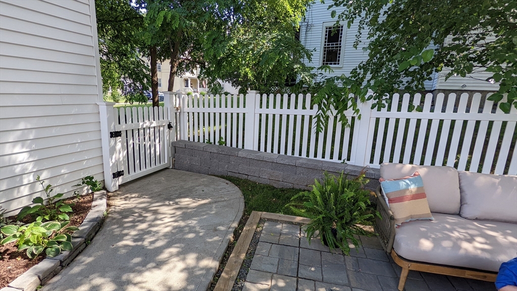 76 Milk Street, Unit 1 Westborough, MA 01581 - Photo 11 of 19 a view of a porch with a bench