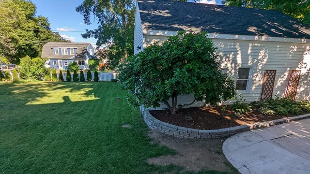 a view of a house with a swimming pool and a yard