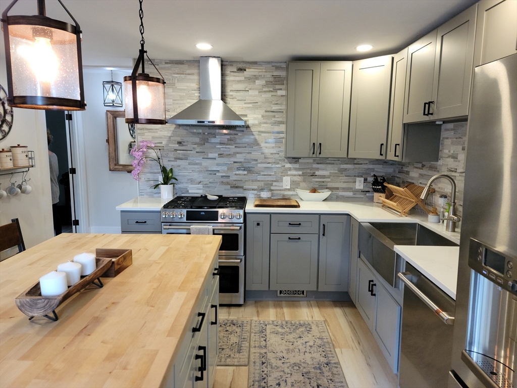 76 Milk Street, Unit 1 Westborough, MA 01581 - Photo 4 of 19 a kitchen with a sink stove and refrigerator