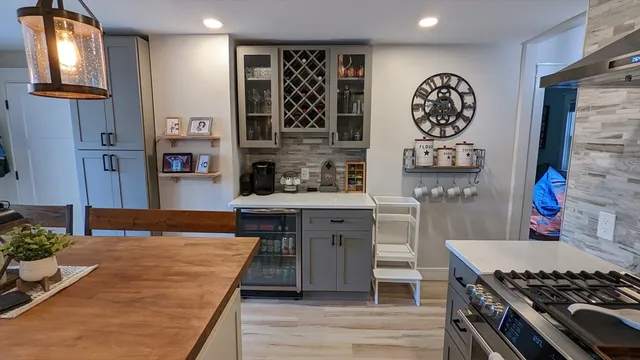 a kitchen with stainless steel appliances granite countertop a stove and cabinets