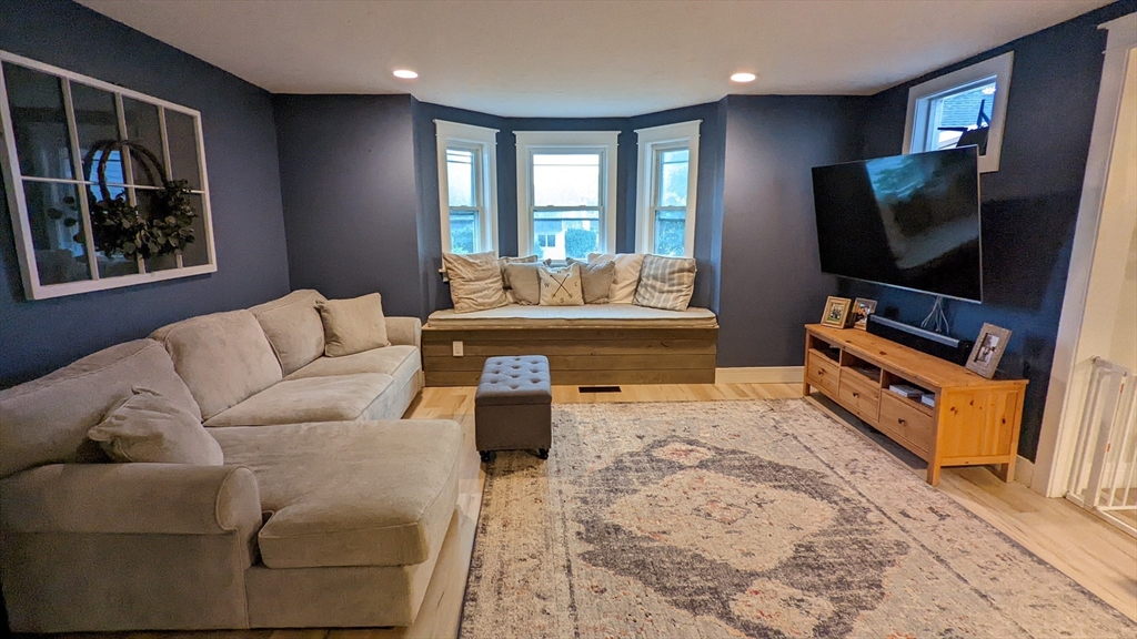 76 Milk Street, Unit 1 Westborough, MA 01581 - Photo 9 of 19 a living room with furniture and a flat screen tv