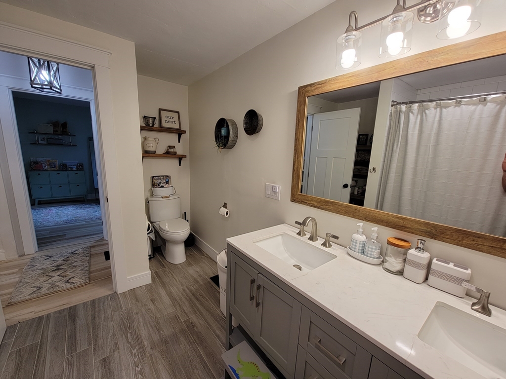 76 Milk Street, Unit 1 Westborough, MA 01581 - Photo 10 of 19 a spacious bathroom with a double vanity sink a mirror and shower