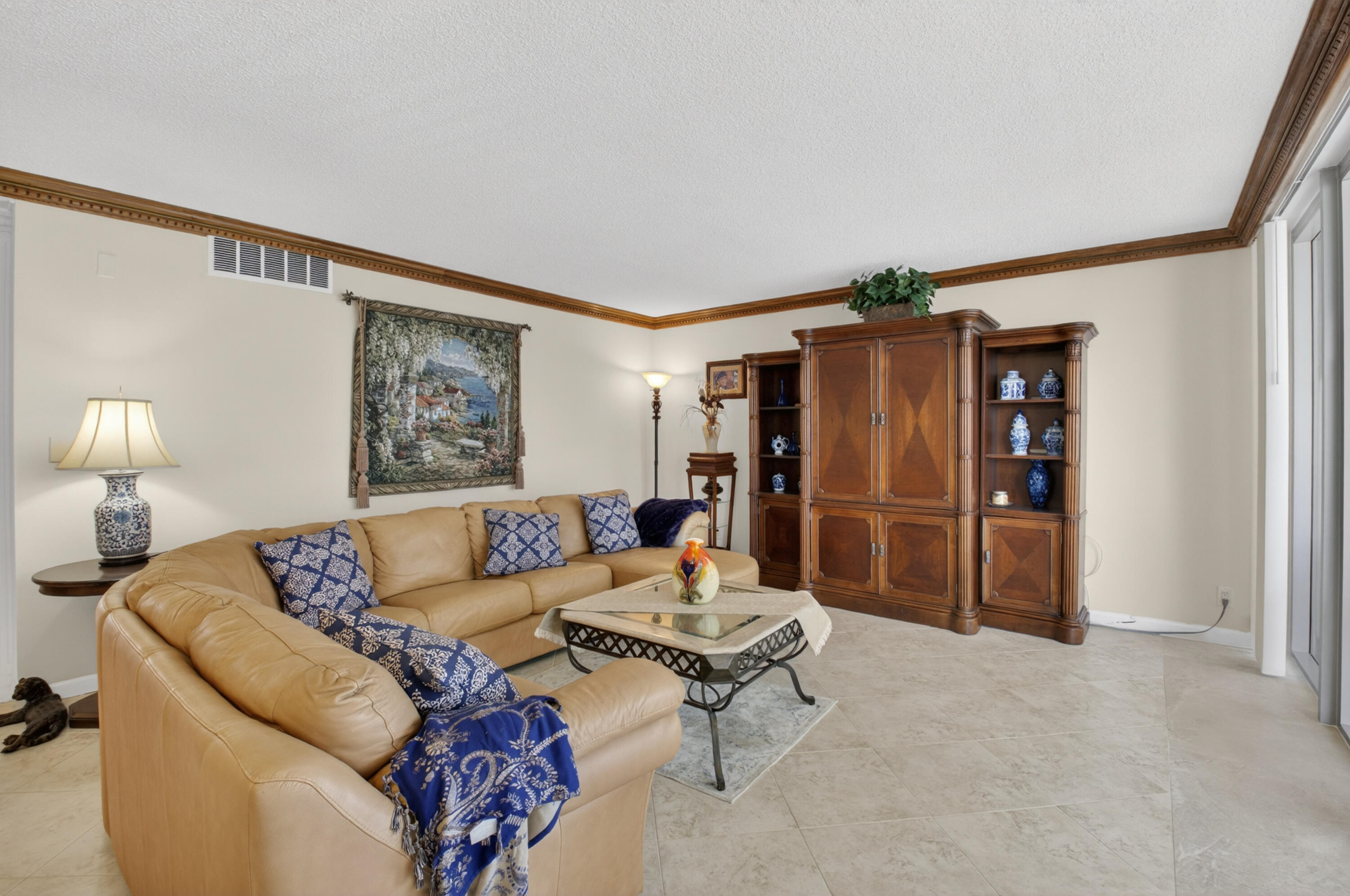 1180 South Ocean Boulevard, Unit 5C Boca Raton, FL 33432 - Photo 19 of 43 a living room with furniture and a flat screen tv