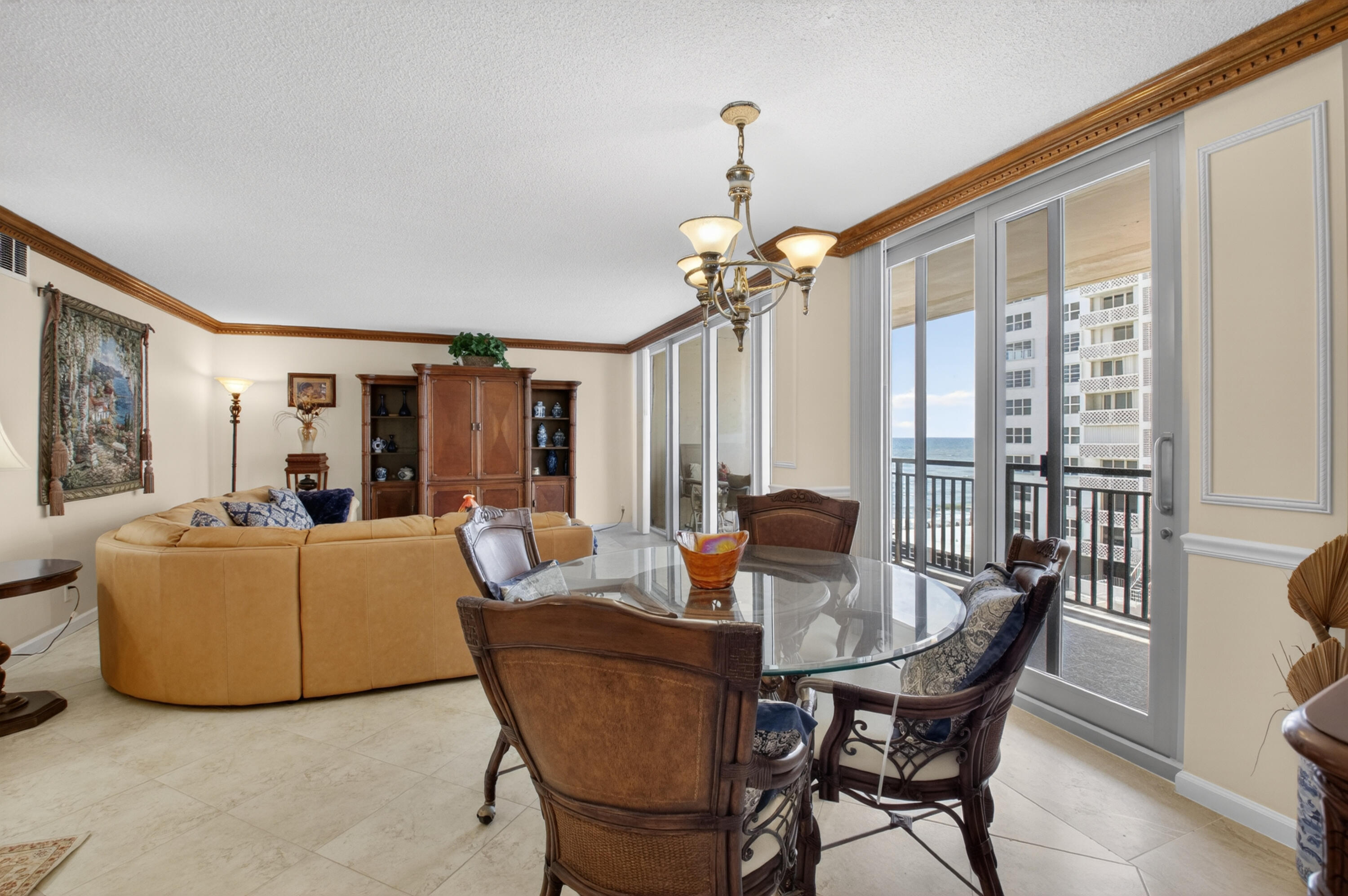 1180 South Ocean Boulevard, Unit 5C Boca Raton, FL 33432 - Photo 22 of 43 a living room with furniture and a chandelier