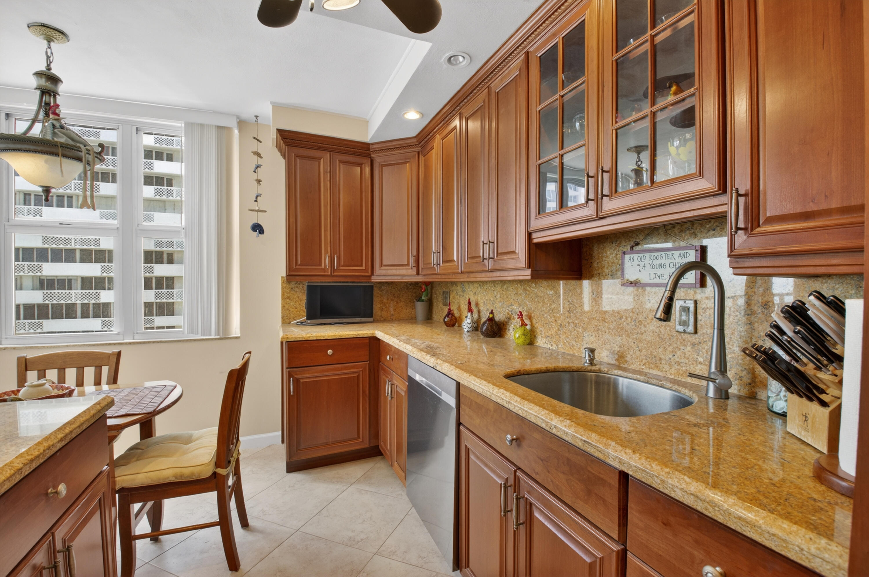 1180 South Ocean Boulevard, Unit 5C Boca Raton, FL 33432 - Photo 25 of 43 a kitchen that has a sink and cabinets