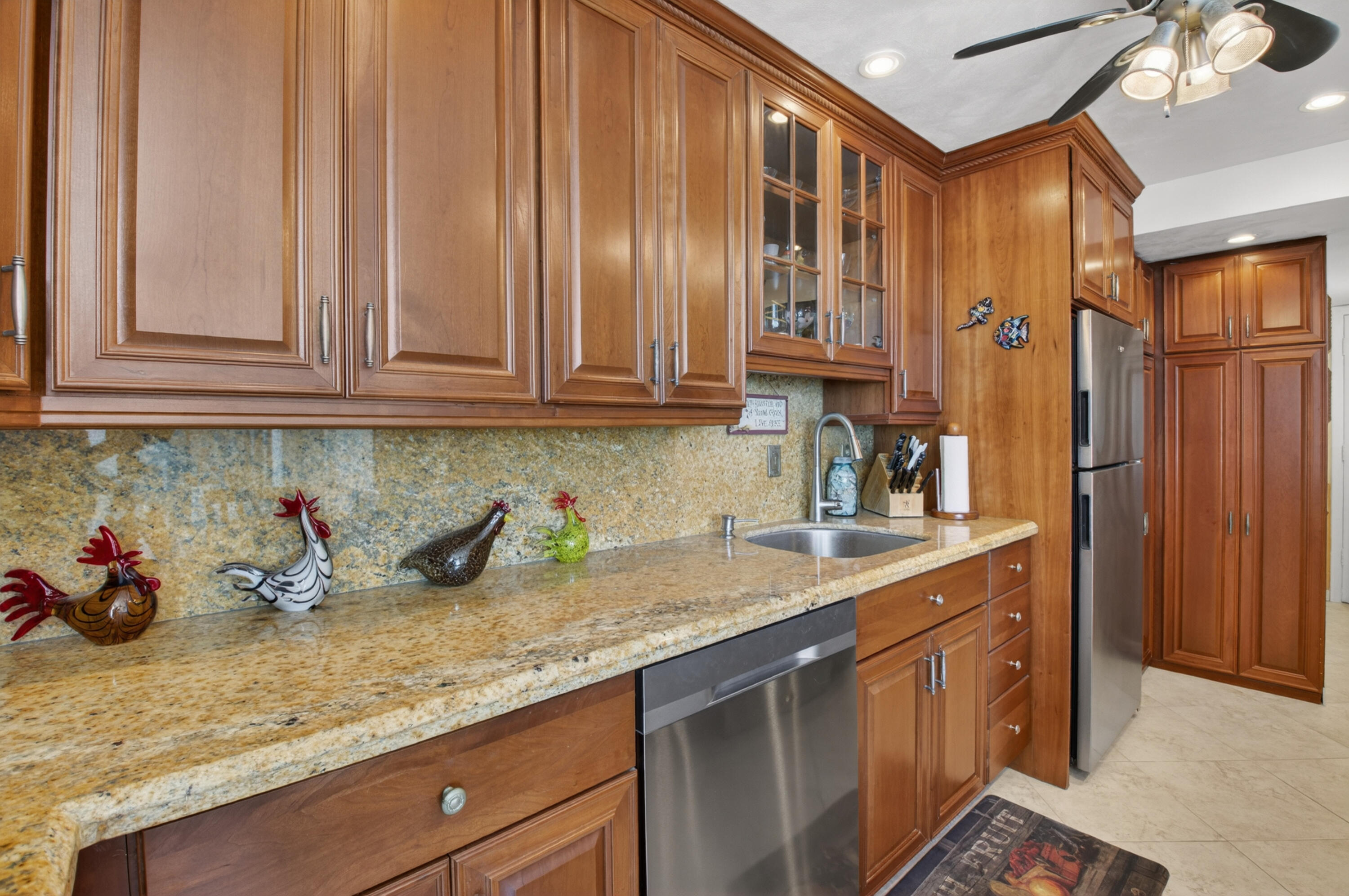 1180 South Ocean Boulevard, Unit 5C Boca Raton, FL 33432 - Photo 27 of 43 a kitchen with stainless steel appliances granite countertop a sink a stove and a refrigerator