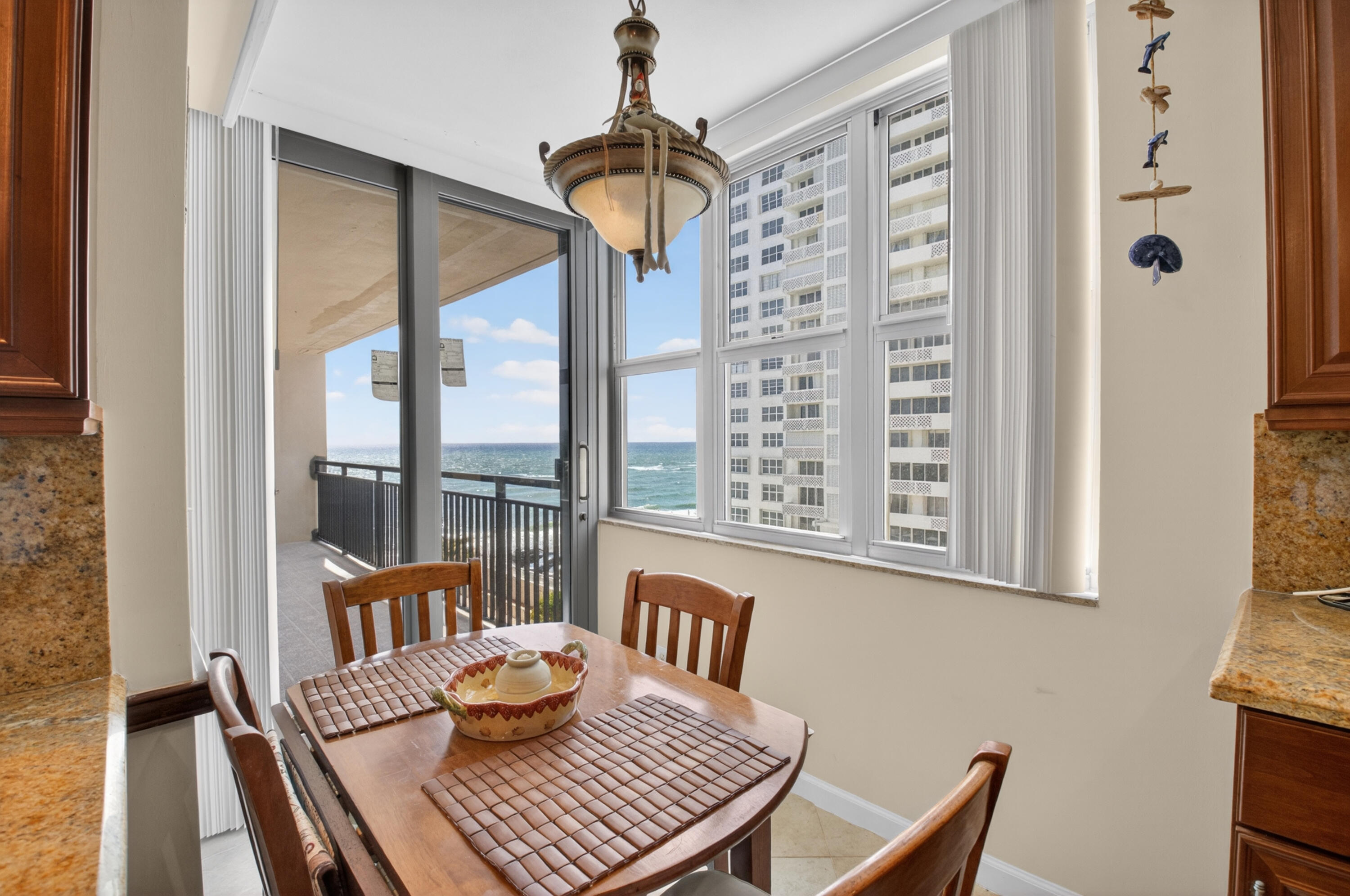 1180 South Ocean Boulevard, Unit 5C Boca Raton, FL 33432 - Photo 28 of 43 a view of a dining room with furniture window and wooden floor