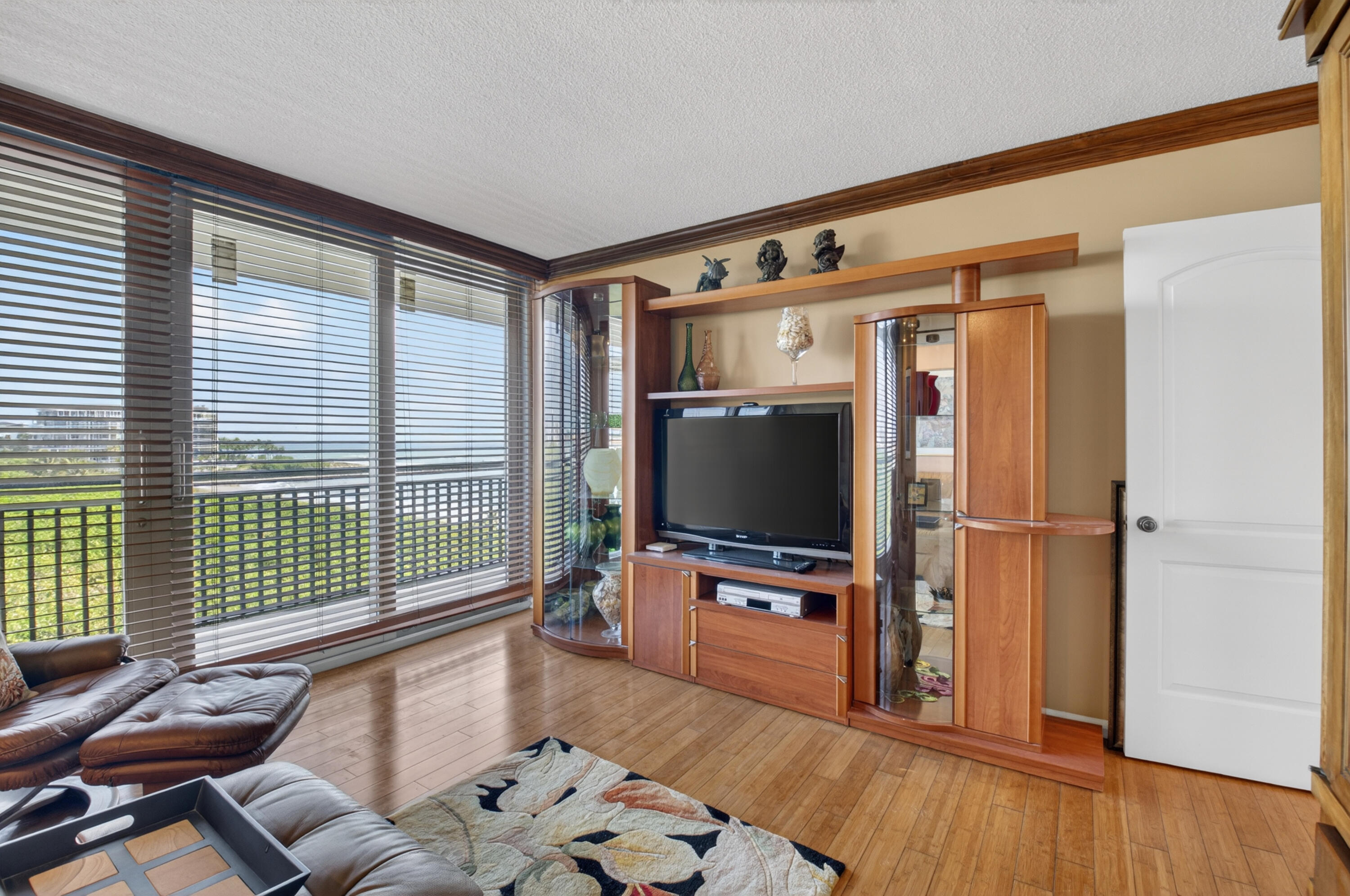 1180 South Ocean Boulevard, Unit 5C Boca Raton, FL 33432 - Photo 37 of 43 a living room with furniture and a flat screen tv
