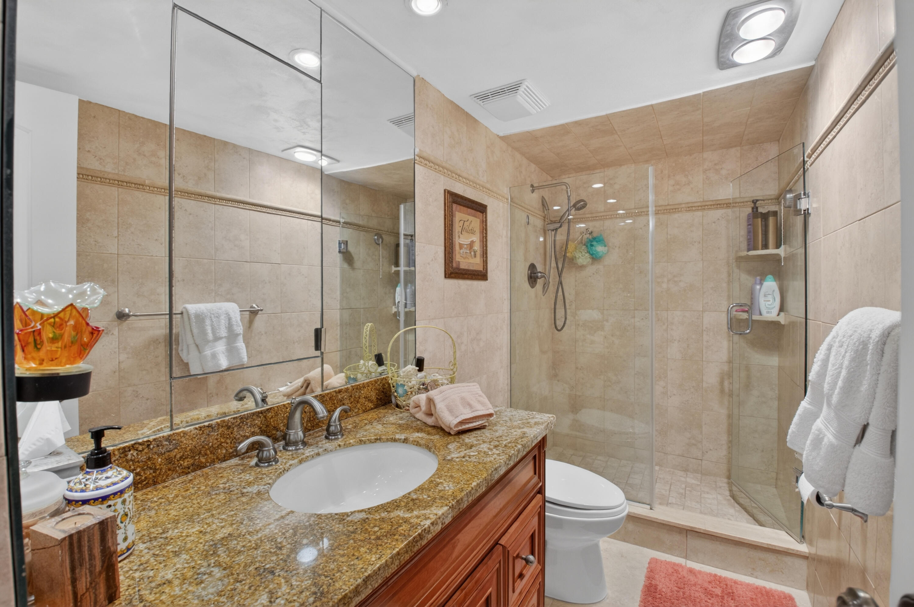 1180 South Ocean Boulevard, Unit 5C Boca Raton, FL 33432 - Photo 38 of 43 a bathroom with a granite countertop sink toilet and shower