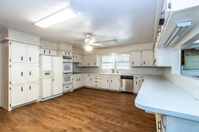 a kitchen with white cabinets and stainless steel appliances