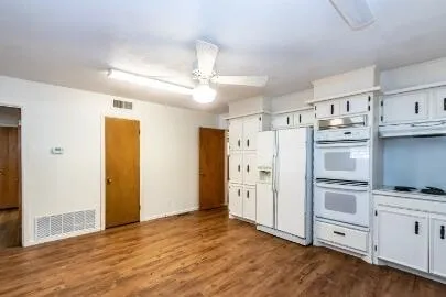 a kitchen with stainless steel appliances a refrigerator sink and cabinets